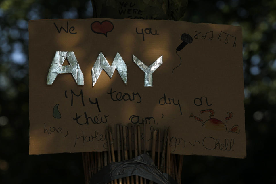 A tribute left for British singer songwriter Amy Winehouse outside her house in London on the first anniversary of her death, Monday, July 23, 2012. (AP Photo/Sang Tan)