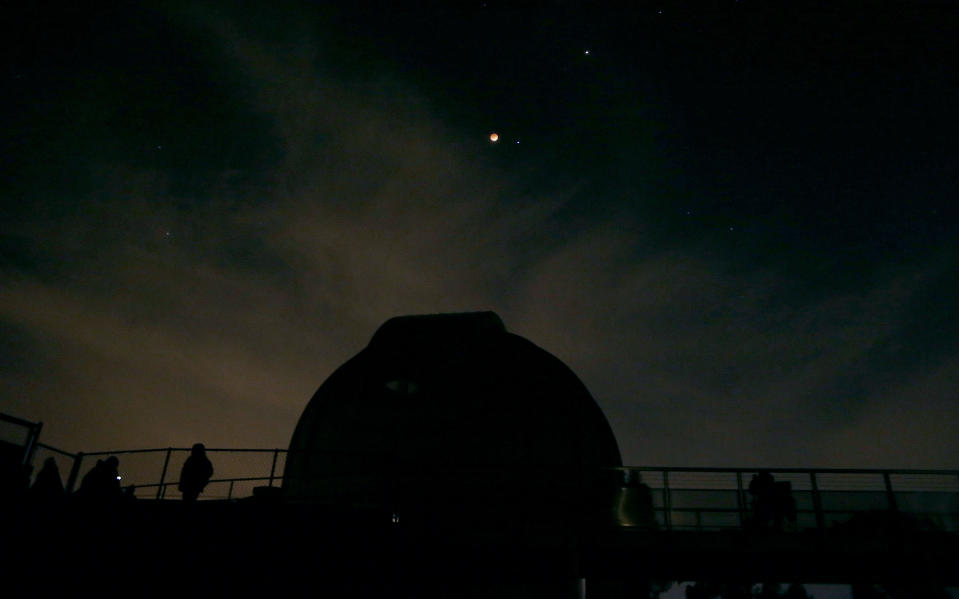 This photo shows the Earth's shadow cast over the surface of the moon as a total lunar eclipse over the Chabot Space and Science Center observatory in Oakland, Calif., Tuesday, April 15, 2014. (AP Photo/Jeff Chiu)