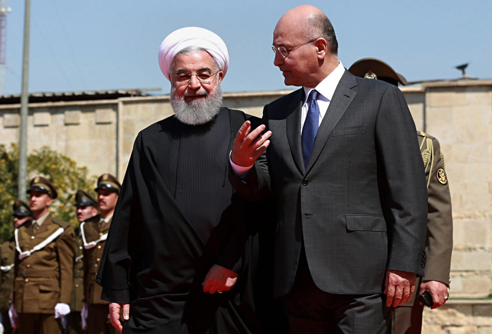 Iraqi President Barham Salih, right, walks with visiting Iranian President Hassan Rouhani, before their meeting at Salam Palace in Baghdad, Iraq, Monday, March 11, 2019. Rouhani is visiting Iraq, seeking to boost ties between the two neighboring states and possibly secure Iraq’s help in bypassing U.S. sanctions the Trump administration re-imposed last year. (AP Photo/Khalid Mohammed)