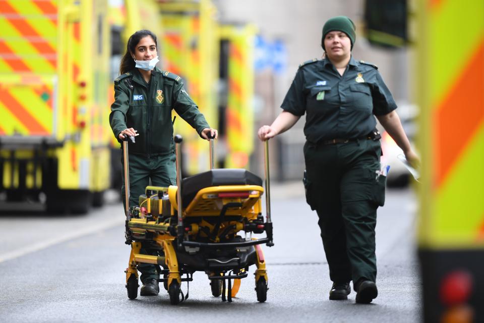 Paramedics wheel a stretcher at the Royal London hospital in London on January 12, 2021 as surging cases of the novel coronavirus are placing health services under increasing pressure. (Photo by DANIEL LEAL-OLIVAS / AFP) (Photo by DANIEL LEAL-OLIVAS/AFP via Getty Images)