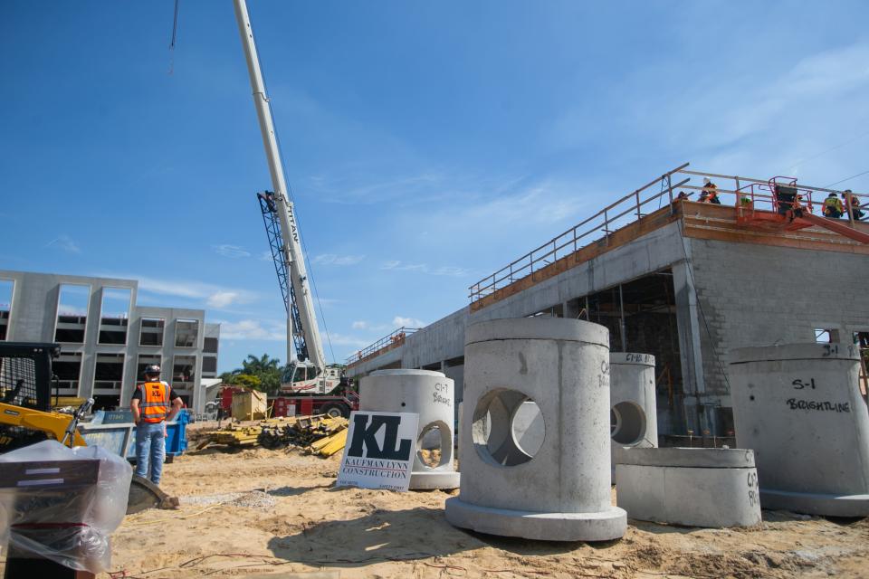 Workers are seen at the site of the future Brightline station and parking garage at 101 N.W. 4th St. in Boca Raton last week. Construction of the station began in January, and the 38,000-square-foot location is scheduled to open by the end of the year.