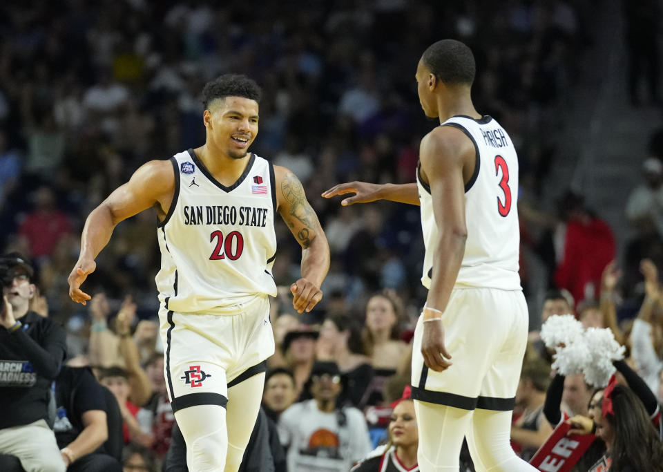 April 1, 2023; Houston, Texas; San Diego State Aztecs guard Matt Bradley (20) and San Diego State Aztecs guard Micah Parrish (3) celebrate against the Florida Atlantic Owls in the semifinals of the Final Four of the 2023 NCAA Tournament at NRG Stadium. Robert Deutsch-USA TODAY Sports