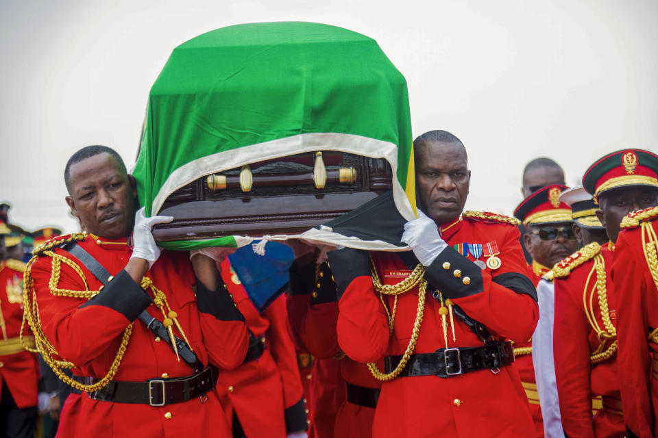 Military officers carry the coffin of former President John Magufuli, draped with the national flag, during a funeral service in his home town of Chato, Tanzania, Friday, March 26, 2021. Some thousands have gathered in the northwestern town of Chato for the burial of former Tanzanian President John Magufuli whose denial of COVID-19 brought the country international criticism. (AP Photo)