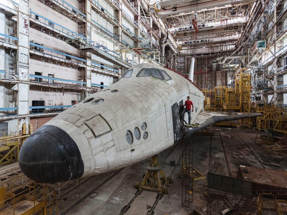 Thissen standing on one of the abandoned space shuttles in the Baikonur Cosmodrome in Kazakhstan.