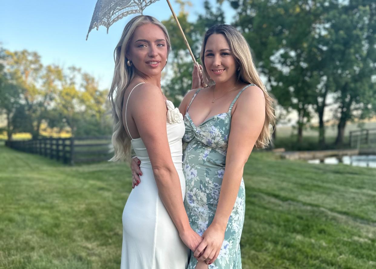 Miranda and Demi Drew at Miranda's wedding reception, outside on a field of grass.