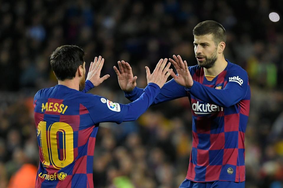 Barcelona's Argentine forward Lionel Messi (pictured left) celebrates with Barcelona's Spanish defender Gerard Pique (pictured right).