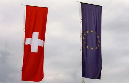 The flags of the European Union and Switzerland flutter in the wind in Blotzheim, France June 27, 2017. REUTERS/Arnd Wiegmann