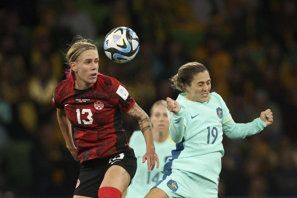 Canada's Sophie Schmidt, left, jumps for the ball with Australia's Katrina Gorry during the Women's World Cup Group B soccer match between Australia and Canada in Melbourne, Australia, Monday, July 31, 2023. (AP Photo/Hamish Blair)