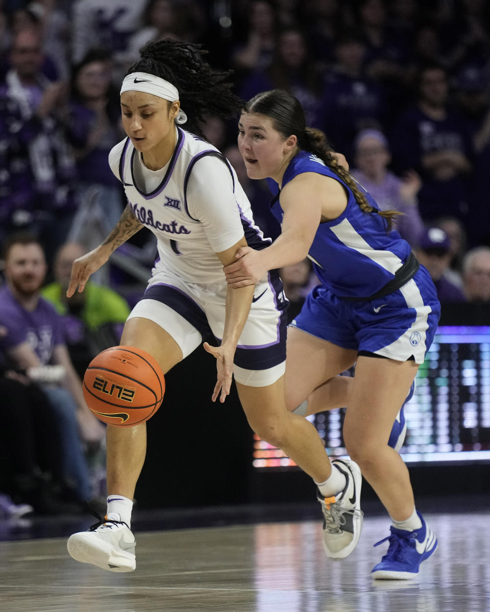 Kansas State guard Zyanna Walker (1) is fouled by BYU guard Kailey Woolston, left, during the second half of an NCAA college basketball game Saturday, Jan. 27, 2024, in Manhattan, Kan. Kansas State won 67-65. (AP Photo/Charlie Riedel)