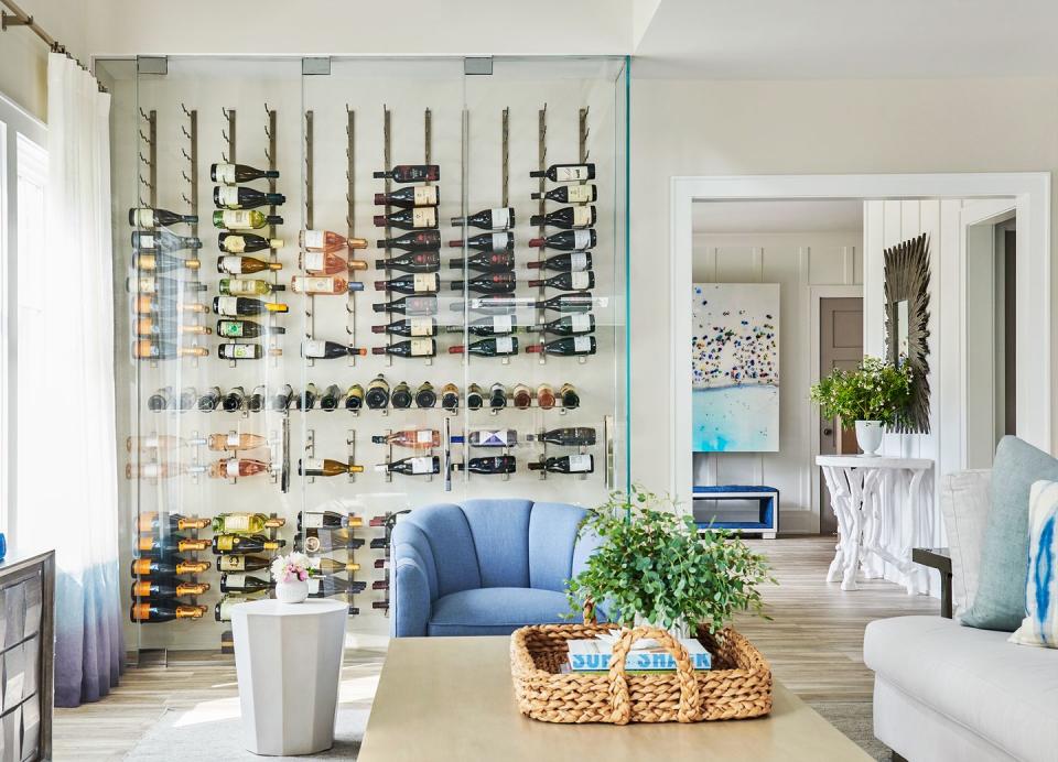 <p>A closet-sized wine cellar can fit in a living room corner while still housings an extensive bottle collection. Just make sure you use the right glass for optimal wine storage, and "be conscious of your exposed, says designer <a href="https://www.morganharrisonhome.com/" rel="nofollow noopener" target="_blank" data-ylk="slk:Michelle Morgan Harrison;elm:context_link;itc:0;sec:content-canvas" class="link ">Michelle Morgan Harrison</a>. Too much direct sunlight accelerates aging, so UV-filtering glass and low-voltage LED bulbs will do wonders. </p>