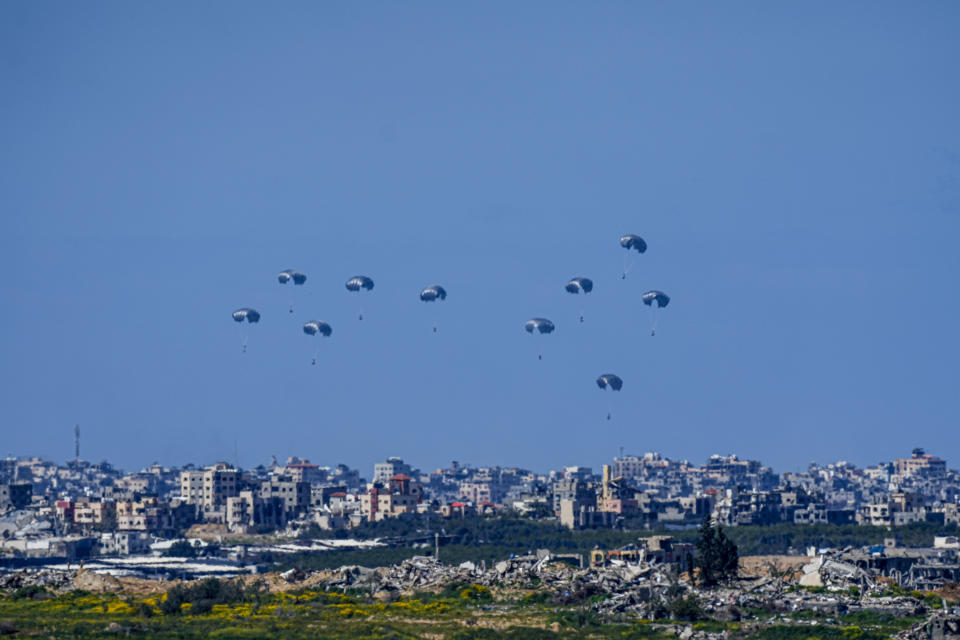 Parachutes drop supplies into the northern Gaza Strip, as seen from southern Israel , Sunday, March 10, 2024. (AP Photo/Ariel Schalit)