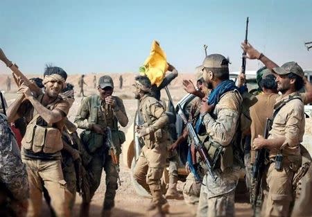 Nujaba fighters gather during an operation in southeast Syria near the border with Iraq and Jordan, in this handout picture released by Tasnim News Agency on July 17, 2017. Tasnim News Agency/Handout via REUTERS