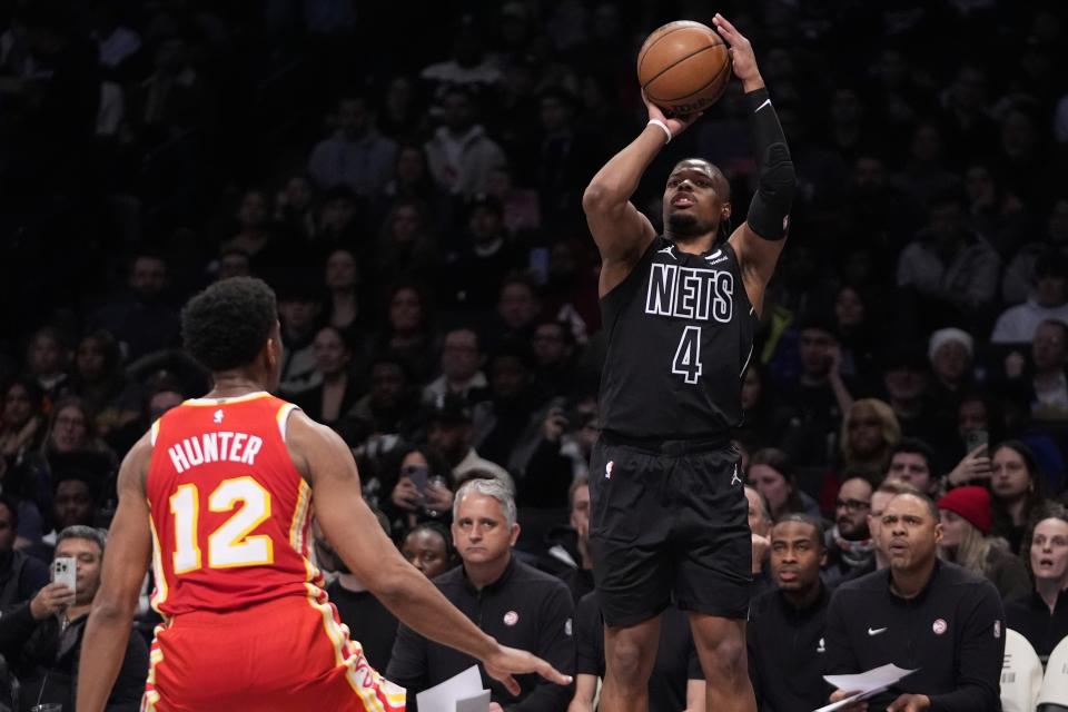 Brooklyn Nets' Dennis Smith Jr. (4) shoots over Atlanta Hawks' De'Andre Hunter (12) during the second half of an NBA basketball game Thursday, Feb. 29, 2024, in New York. (AP Photo/Frank Franklin II)