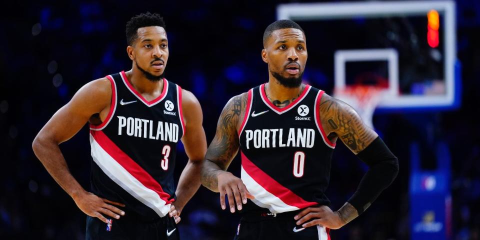 CJ McCollum and Damian Lillard stand with their hands on their hips during a game in 2021.