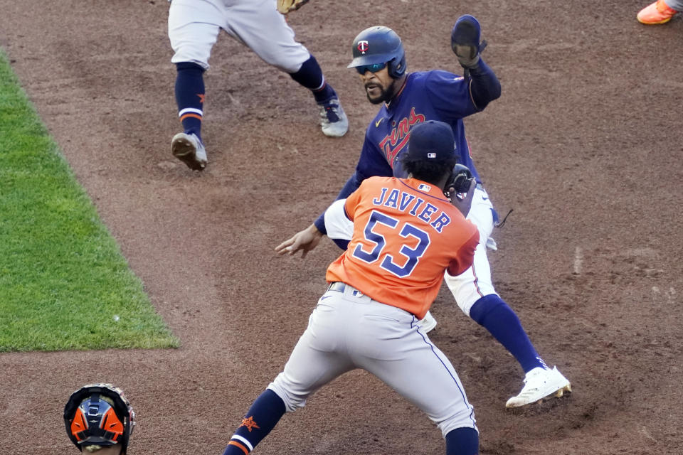 Houston Astros pitcher Cristian Javier (53) tags out Minnesota Twins' Byron Buxton during an eighth inning rundown between first and second in Game 2 of a American League wild-card baseball series, Wednesday, Sept. 30, 2020, in Minneapolis. The Astros won the series with their 3-1 win. (AP Photo/Jim Mone)