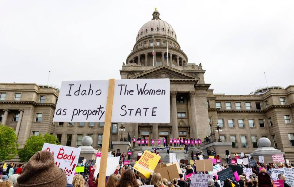 An attendee at an abortion rights rally holds a sign outside the Idaho Capitol