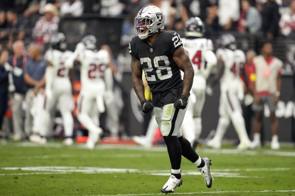 Las Vegas Raiders running back Josh Jacobs celebrates his touchdown during the second half of an NFL football game against the Houston Texans, Sunday, Oct. 23, 2022, in Las Vegas. (AP Photo/John Locher)