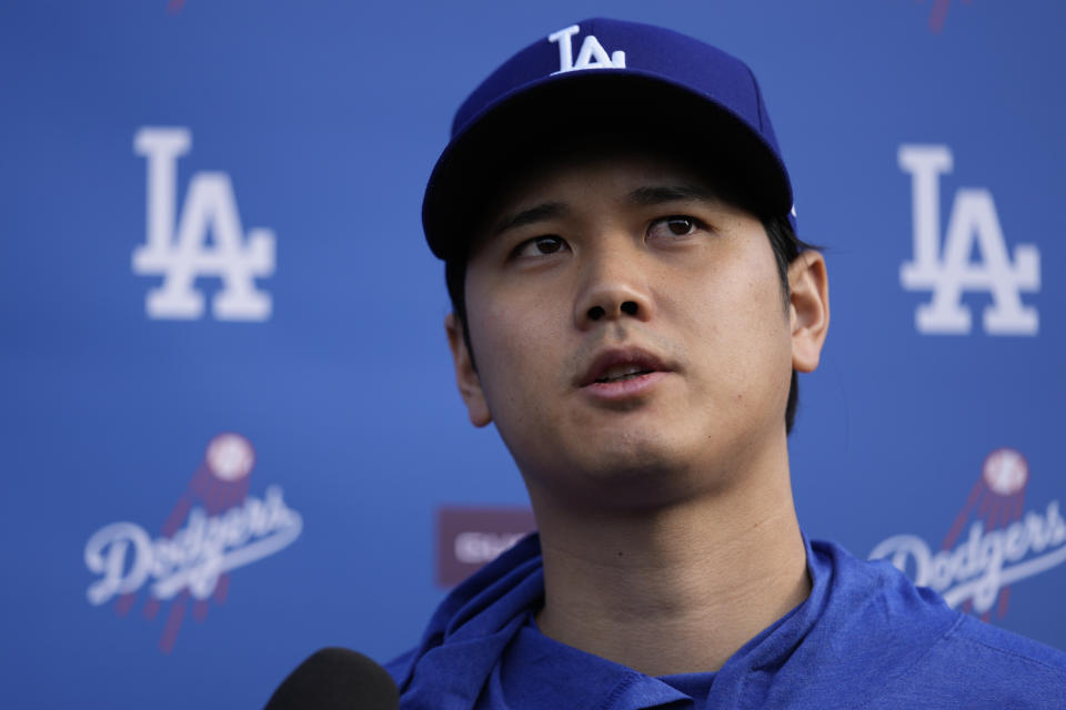 Los Angeles Dodgers' Shohei Ohtani speaks to media at Camelback Ranch in Phoenix, Friday, Feb. 9, 2024, on the first day of spring training baseball workouts for the Dodgers. (AP Photo/Carolyn Kaster)