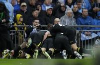 Wigan players celebrate Wigan Athletic's midfielder Ben Watson's goal during the English FA Cup final at Wembley Stadium in London on May 11, 2013. Wigan won 1-0