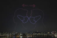 In this on Saturday, July 4, 2020, photo, some 400 drones fly over the Han River showing messages of appreciation for medical workers during the coronavirus pandemic in Seoul, South Korea. (Lim Hwa-young/Yonhap via AP)