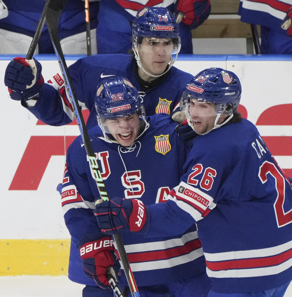 United States' Isaac Howard (22) celebrates his goal against Sweden with teammates Cutter Gauthier (19) and Seamus Casey (26) during the second period of the gold medal game at the IIHF World Junior Hockey Championship in Gothenburg, Sweden, Friday, Jan. 5, 2024. (Christinne Muschi/The Canadian Press via AP)