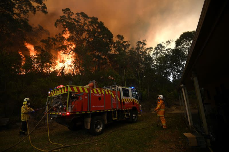 NSW Rural Fire Service and Fire and Rescue NSW crews work to protect a property on Kyola Road in Kulnura