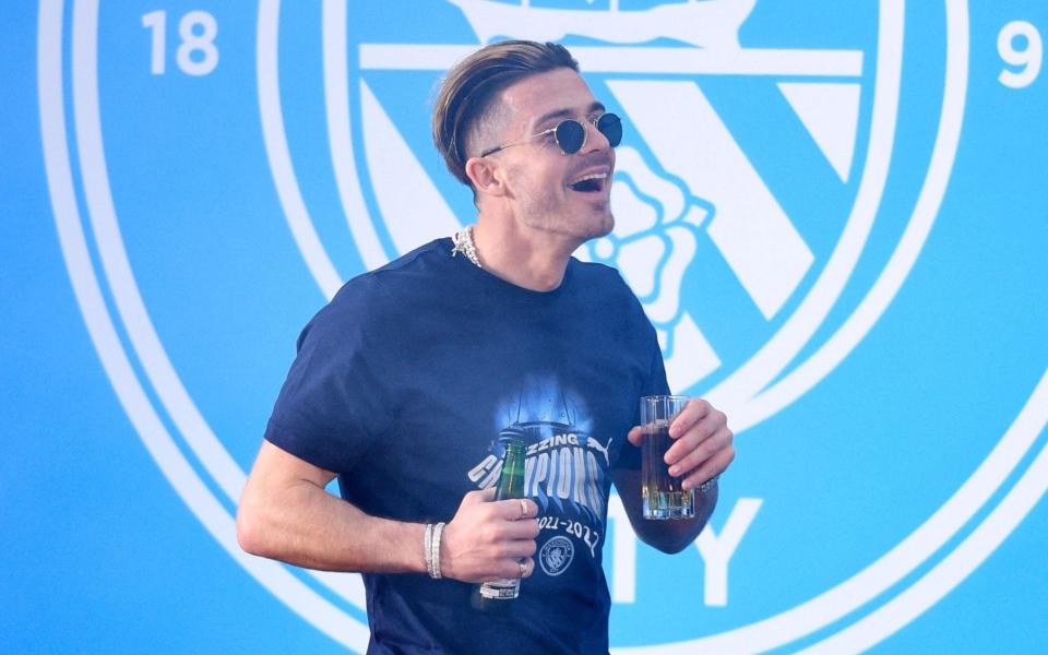 Manchester City's English midfielder Jack Grealish attends an event for fans with members of the Manchester City football team following an open-top bus parade through Manchester, north-west England on May 23, 2022, to celebrate winning the 2021-22 Premier League title. - GETTY IMAGES