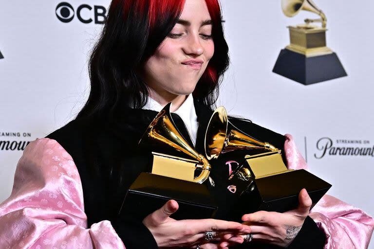 US singer-songwriter Billie Eilish poses in the press room with the Grammys for Song of the Year and Best Song Written Visual Media for 