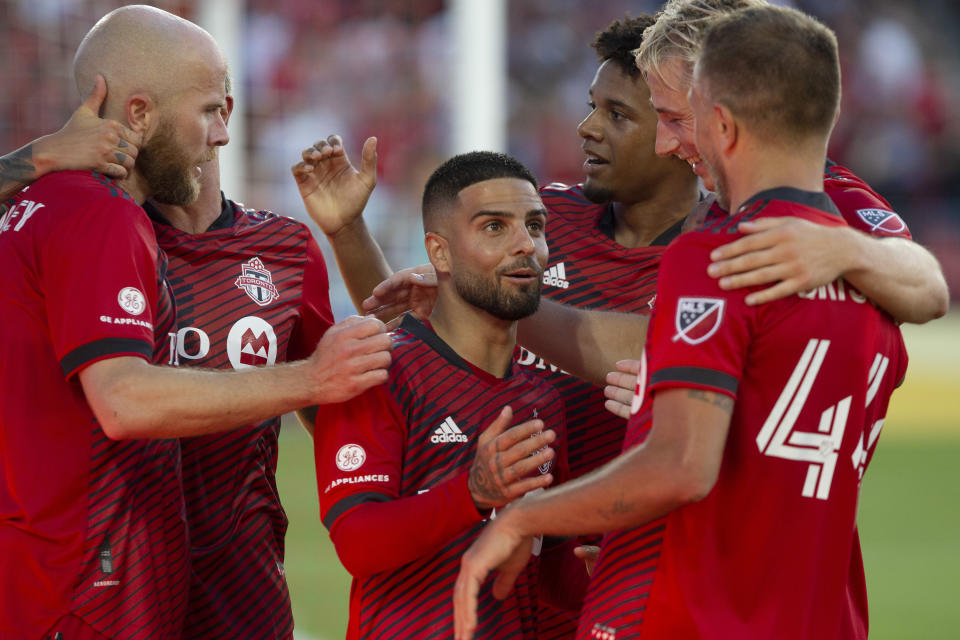 Toronto FC's Lorenzo Insigne, center, celebrates with teammates after Michael Bradley, left, scored against Charlotte FC during the first half of an MLS soccer match Saturday, July 23, 2022, in Toronto. (Chris Young/The Canadian Press via AP)