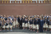<p>President of Russia’s Olympic Committee Alexander Zhukov, fourth right, and Sports Minister Vitaly Mutko, center, pose for a photo with Russia’s National Olympic team members outside the Kremlin wall, before a meeting with Russian President Vladimir Putin, in Moscow, Russia, July 27, 2016. (Photo: Pavel Golovkin/AP)</p>