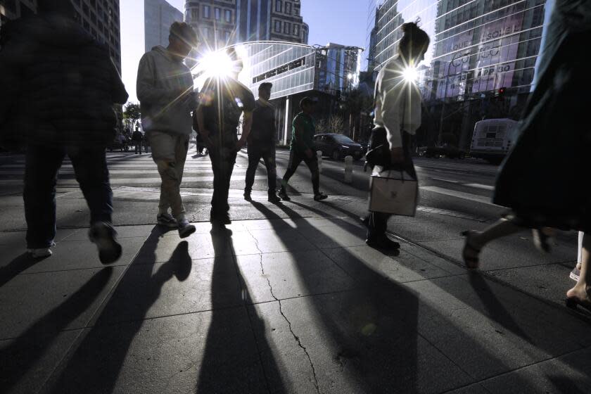 LOS ANGELES, CA - APRIL 10, 2023 - Pedestrians make their way through the streets of downtown Los Angeles on April 10, 2023. Genaro Molina / Los Angeles Times)