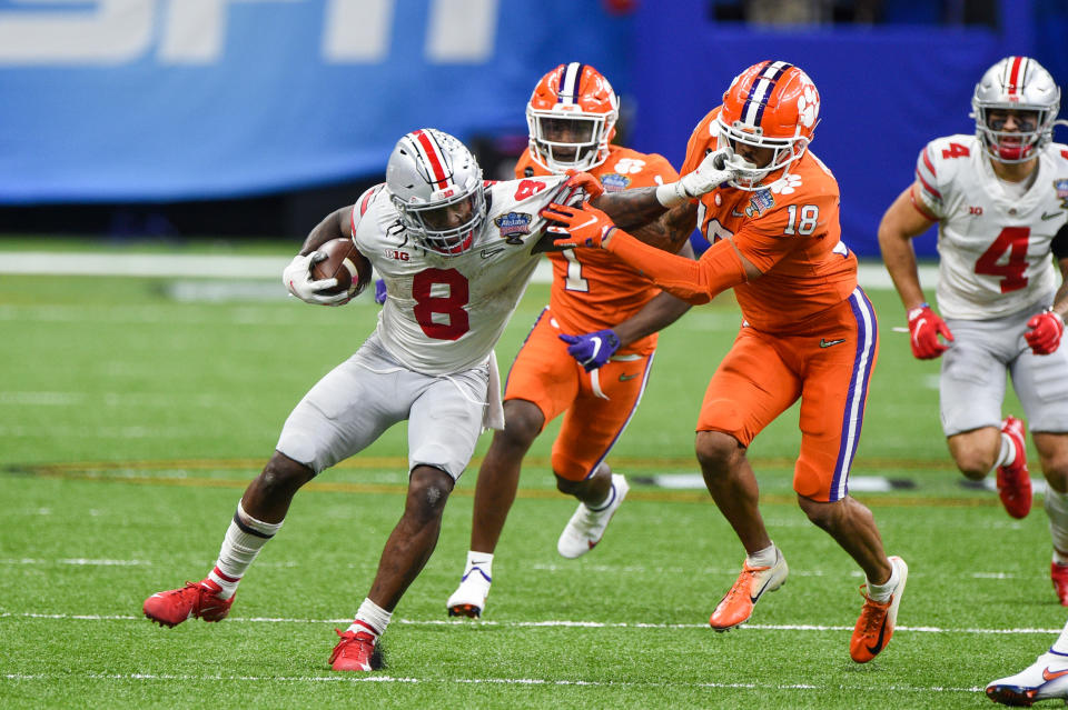 Ohio State Buckeyes RB Trey Sermon (8) attempts to breaks a tackle attempt by Clemson Tigers safety Joseph Charleston (18) during the Sugar Bowl on Jan. 1. (Ken Murray/Icon Sportswire via Getty Images)