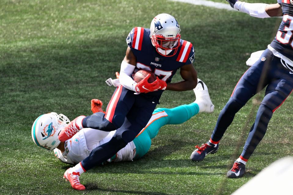 Patriots cornerback J.C. Jackson intercepts a pass intended for Dolphins tight end Mike Gesicki during the 2020 season.