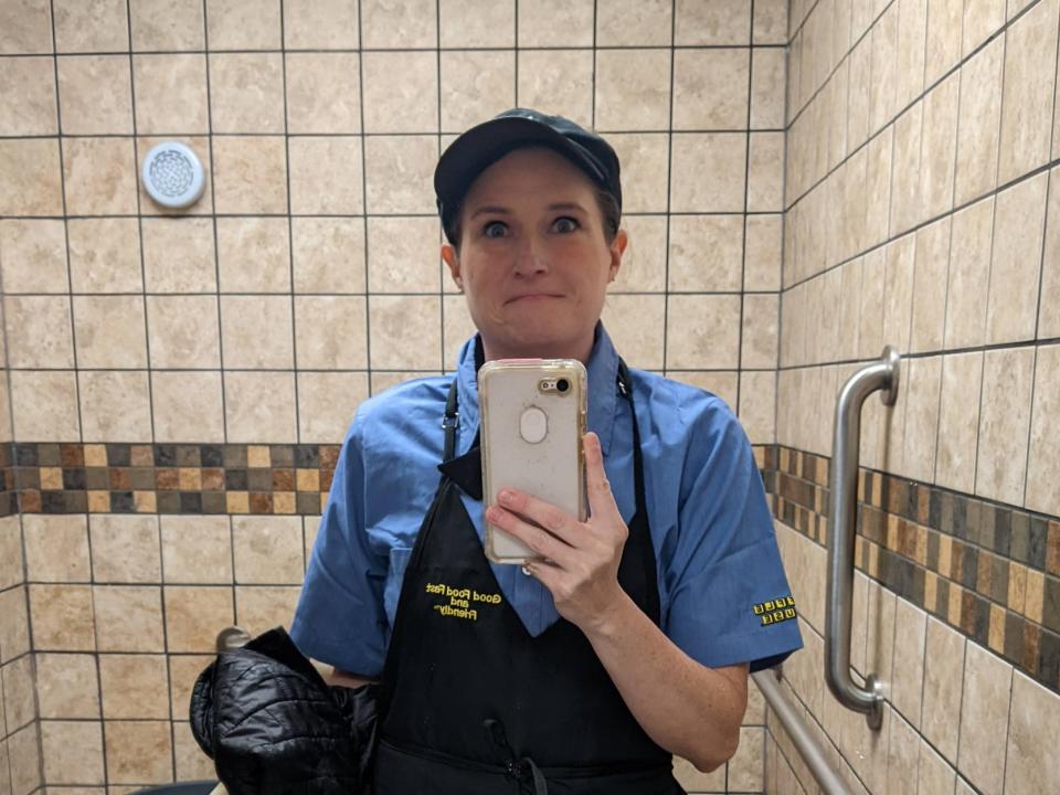 Amanda Claypool taking a selfie at Waffle House in her uniform.