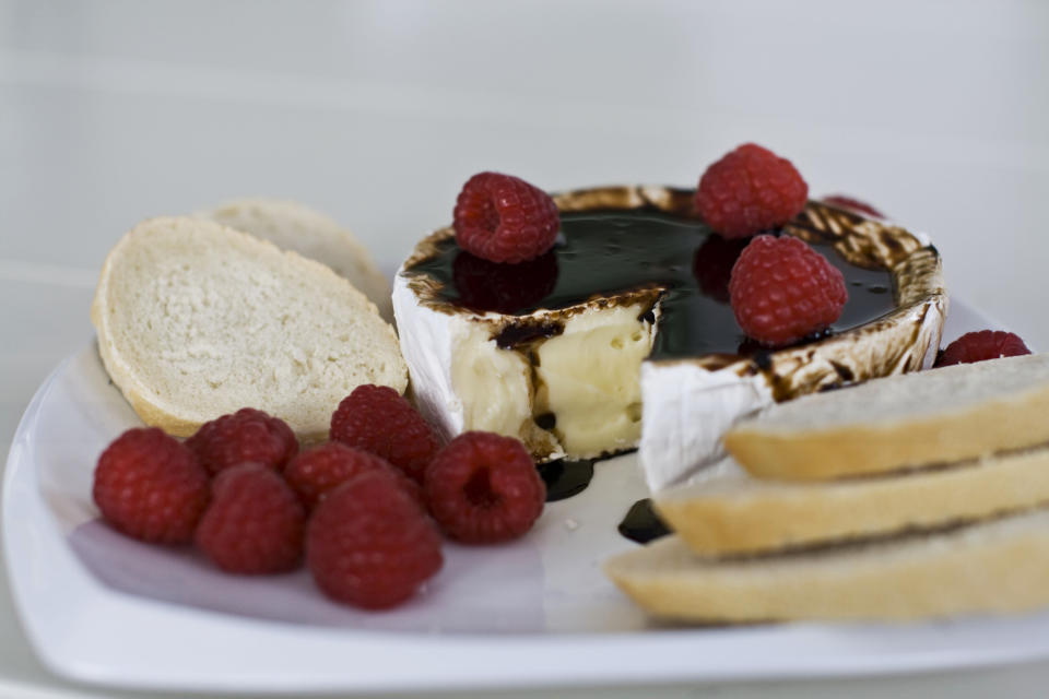 In this image taken on Monday, November 26, 2012, brie with bourbon-balsamic glaze is shown on a platter in Concord, N.H. (AP Photo/Matthew Mead)
