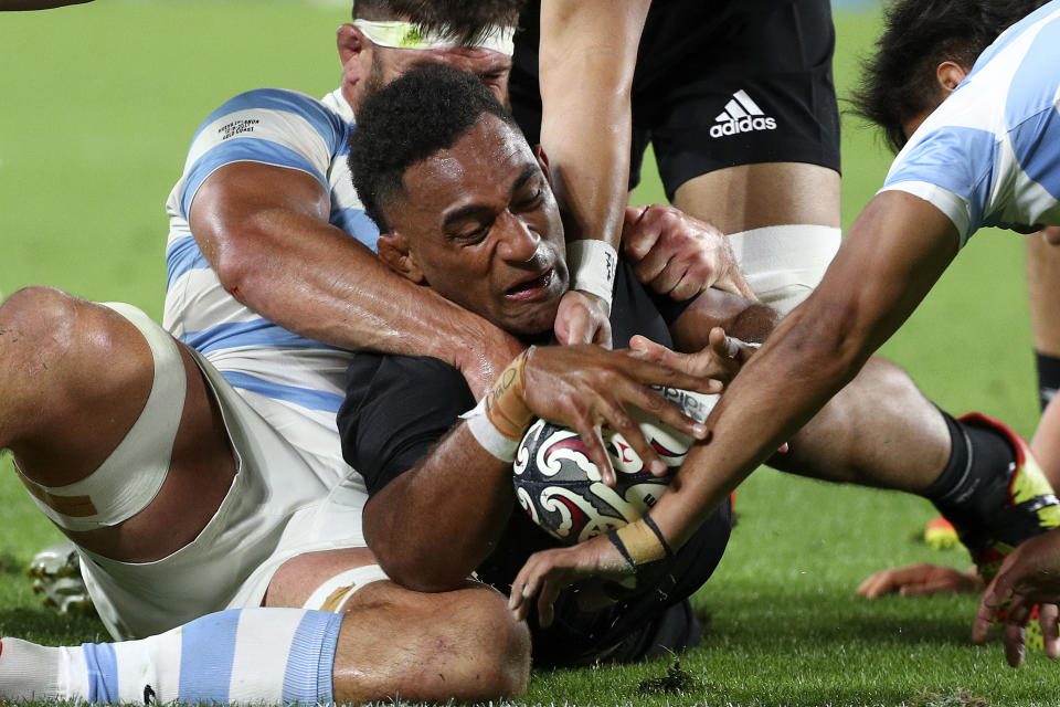 New Zealand's Sevu Reece, center, has his try attempt spoiled by the Argentine defense during their Rugby Championship match on Sunday, Sept. 12, 2021, on the Gold Coast, Australia. (AP Photo/Tertius Pickard)