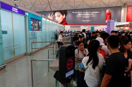 Security gates are seen closed at a mass anti-extradition bill demonstration after a woman was shot in the eye during a protest at Hong Kong International Airport, in Hong Kong