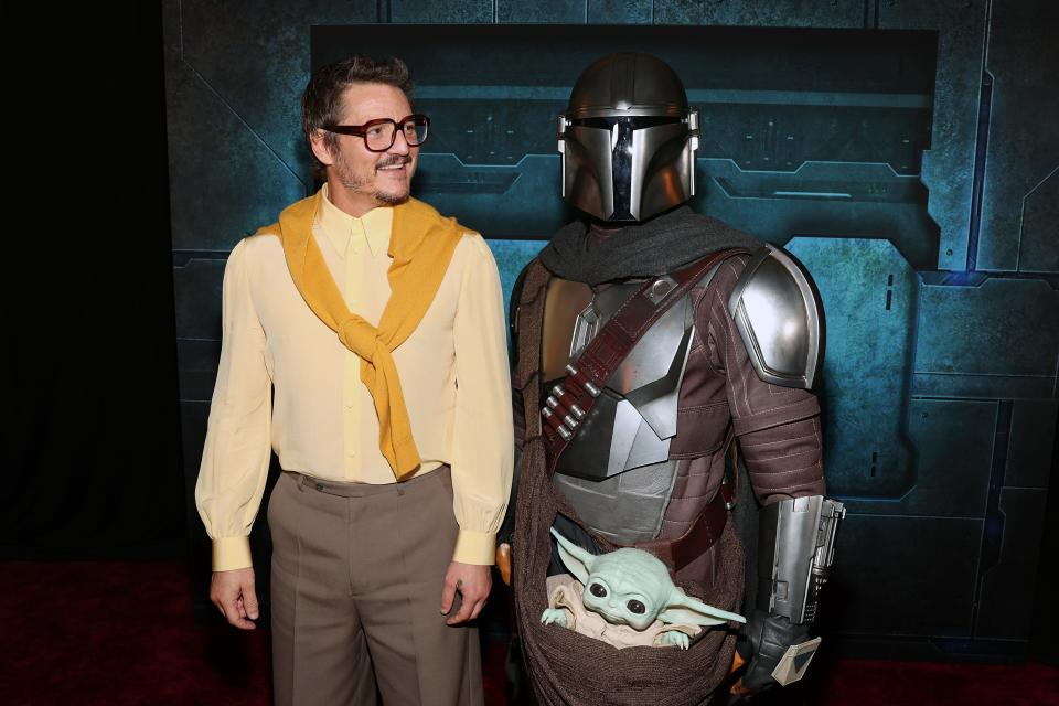 Pedro Pascal and a person dressed as Din Djarin at "The Mandalorian" special launch event at El Capitan Theatre in Hollywood, California.