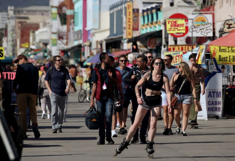 VENICE BEACH, CA - FEB. 9, 2022. People enjoy the sun along the Venice Beach Boardwalk as temperatures reached into the mid-80s in Southern California on Wednesday, Feb. 9, 2022. Warm weather is expected to continue through the Super Bowl weekend. (Luis Sinco / Los Angeles Times)