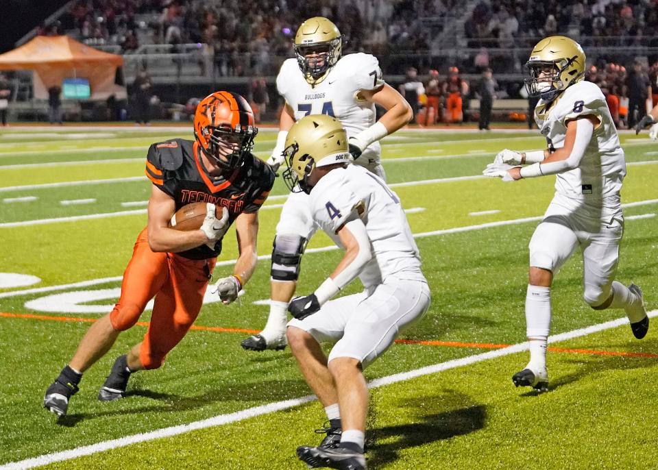 Tecumseh's AJ Bryan carries the ball during Friday's game against Chelsea.