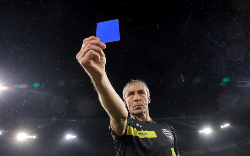 Referee holds up a blue card