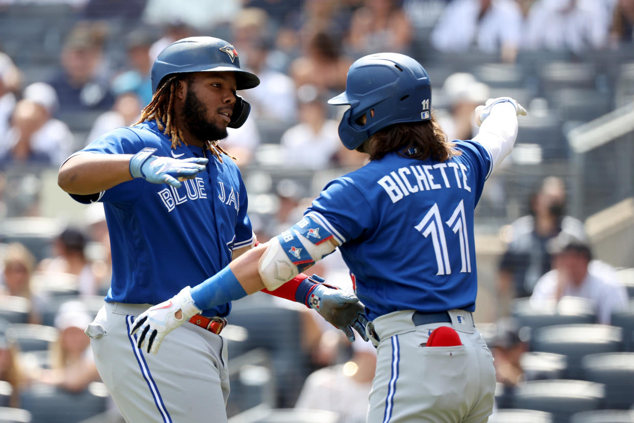 NEW YORK, NEW YORK - SEPTEMBER 06: Vladimir Guerrero Jr. #27 celebrates his first inning home run with teammate Bo Bichette #11 of the Toronto Blue Jays during a game aginst the New York Yankees at Yankee Stadium on September 06, 2021 in the Bronx borough of New York City. (Photo by Dustin Satloff/Getty Images)