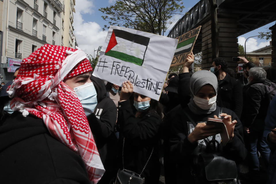 Protesters gather during a banned protest in support of Palestinians in the Gaza Strip, Saturday, May, 15, 2021 in Paris. Marches in support of Palestinians in the Gaza Strip were being held Saturday in a dozen French cities, but the focus was on Paris, where riot police got ready as organizers said they would defy a ban on the protest. (AP Photo/Michel Euler)