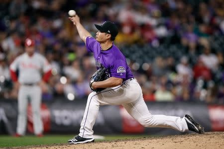 Apr 20, 2019; Denver, CO, USA; Colorado Rockies relief pitcher Seunghwan Oh (18) pitches in the ninth inning against the Philadelphia Phillies at Coors Field. Mandatory Credit: Isaiah J. Downing-USA TODAY Sports