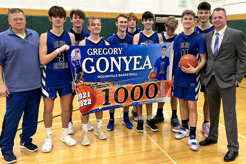 Dolgeville senior Gregory Gonyea (with ball) scored the 1,000th point of his varsity basketball career Tuesday during the Blue Devils' 65-36 Section III quarterfinal victory at Weedsport. Gonyea entered the game needing 21 points and scored 28.