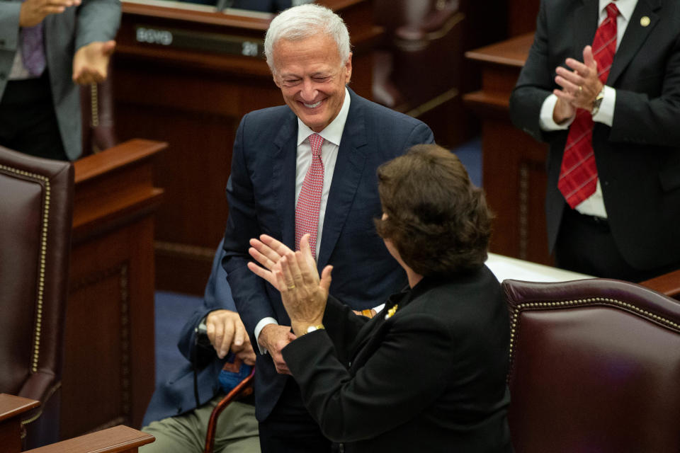 John Passidomo, husband of Sen. Kathleen Passidomo, smiles as he's introduce during a meeting of the Florida Senate Republican Caucus where the body formally designated Sen. Passidomo as the next Senate President at the Capitol Tuesday, Oct. 19, 2021.
