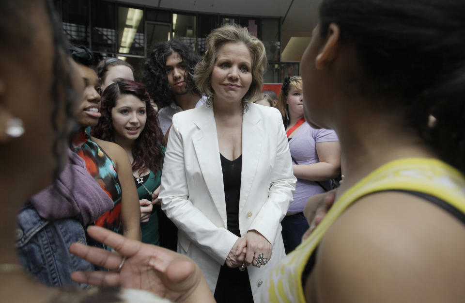 In this March 19, 2012 photo, famed soprano Renee Fleming talks to the students after performing with a choir of dozens of high school students in the rotunda of the State of Illinois building, the James R. Thompson Center, in Chicago. For the past school year the opera singer has been mentoring teenaged vocal students in Chicago as part of her role as creative consultant at the Lyric Opera of Chicago.(AP Photo/Kiichiro Sato)