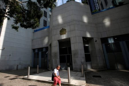 A man walks next to British Cosulate-general office in Hong Kong