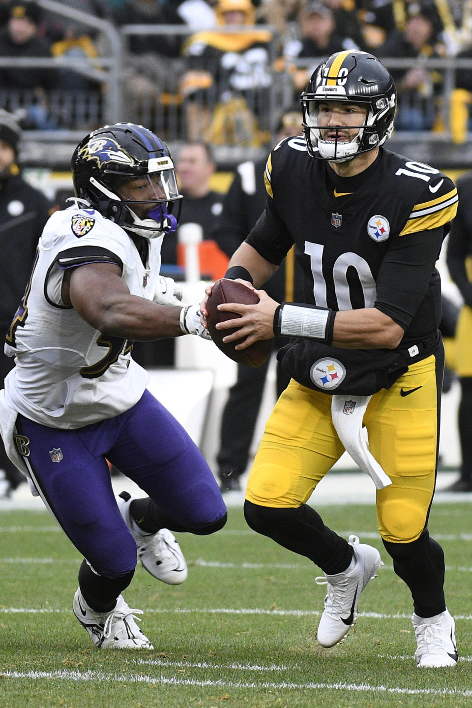 Pittsburgh Steelers quarterback Mitch Trubisky (10) looks to pass under pressure from Baltimore Ravens linebacker Tyus Bowser during the second half of an NFL football game in Pittsburgh, Sunday, Dec. 11, 2022. (AP Photo/Don Wright)