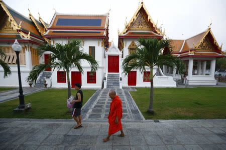 A Buddhist monk walks in a monastery in Bangkok, Thailand, January 14, 2016. REUTERS/Jorge Silva